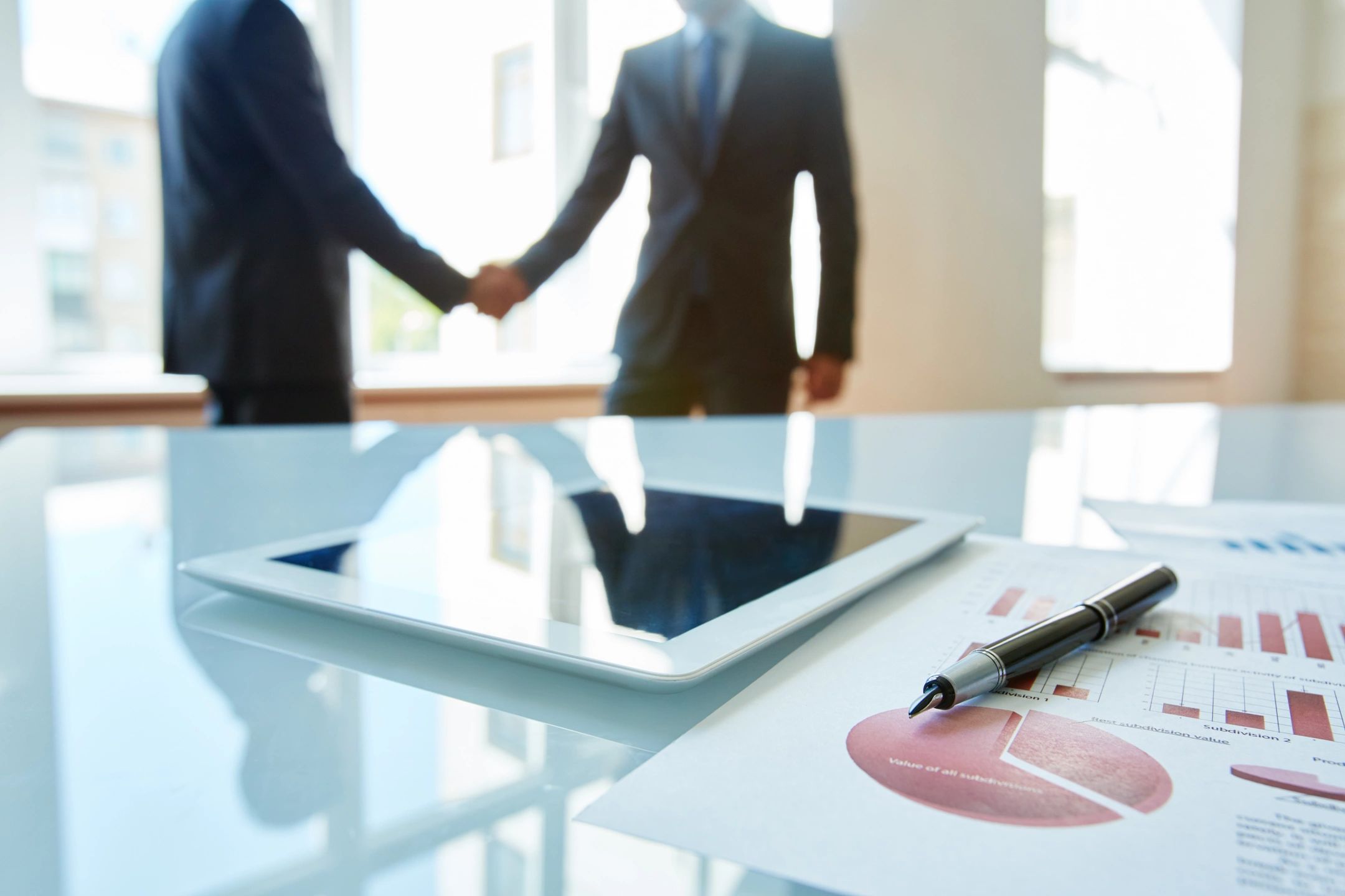 Businessmen shake hands over a contract well-executed
